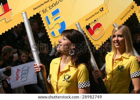 DUSSELDORF, GERMANY - APRIL 19:  Grid girls enter the city track of the DTM 2009 presentation April  19, 2009 in Dusseldorf, Germany. About 210,000 spectators witnessed the event.