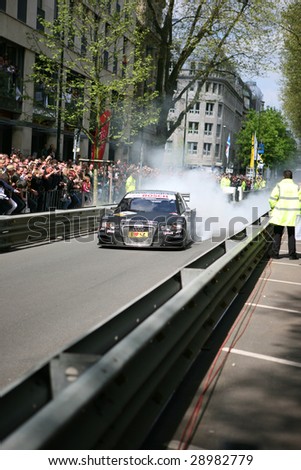 DUSSELDORF, GERMANY - APRIL 19: AUDI touring car performs a burnout on the city circuit of the DTM 2009 presentation April 19, 2009 in Dusseldorf. About 210,000 spectators witnessed the event.