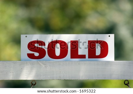 Real Estate sold sign with soft focus background