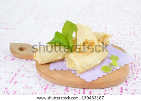 Bread for breakfast with green leaves on the wooden board