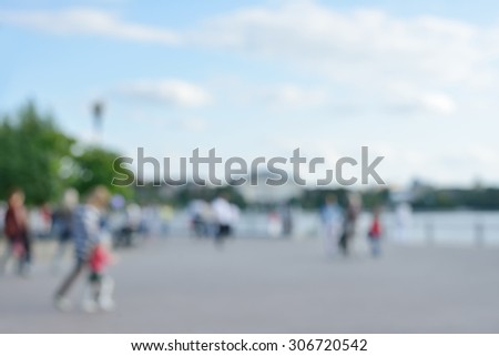 Blurred background of people activities in park with bokeh, spring and summer season. Blurred people near lake.
