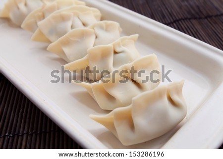 Plate of Raw Chinese dumplings in a row