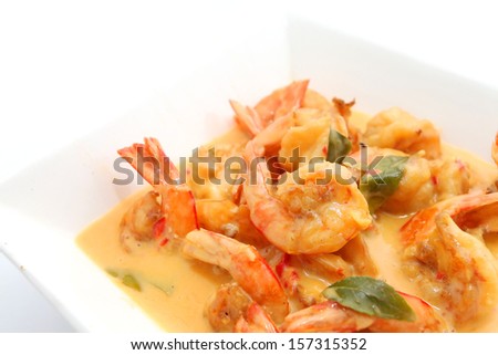 Shrimp in butter and cheese sauce on a white plate