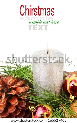 Silver candle with the baubles and cones on white