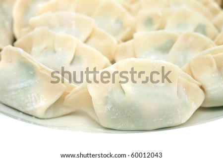 Raw chinese dumplings isolated on white background