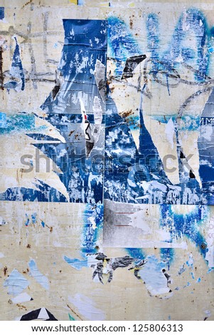 Grunge background on billboard with old torn posters / Torn street poster /