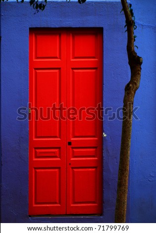 Colorful red door on violet wall / Barcelona, Spain