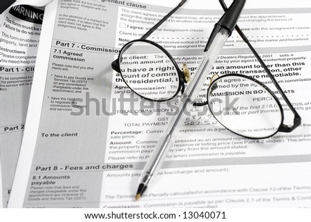 Close up of Real Estate contract with reading glasses and pen