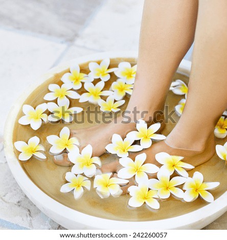 Slim legs of beautiful girl with aromatherapy bowl