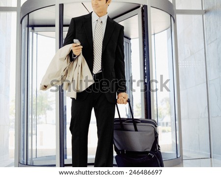 Businessman with his luggage near an escalator