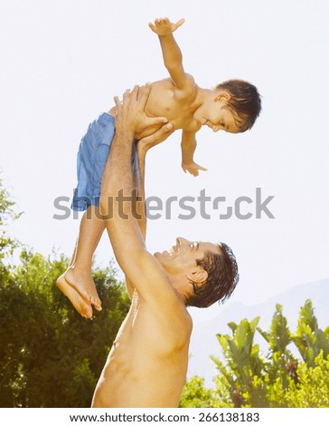 Father and son holding hand in hand outdoor, motion blur, warm tone