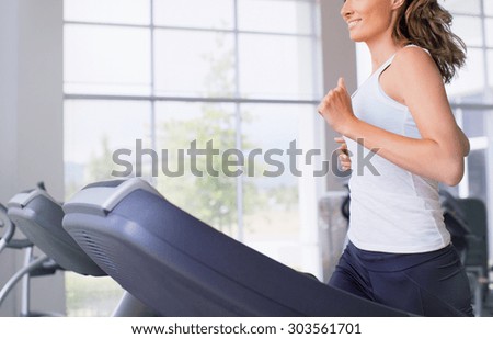 Young woman running on treadmill