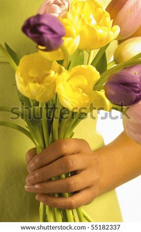 attractive brunette holding bunch of flowers