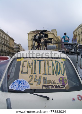 MADRID; SPAIN - MAY 22: Popular demonstration against political class on May 22, 2011 in Madrid; Spain.Television car placed at the middle of the Spanish Revolution.