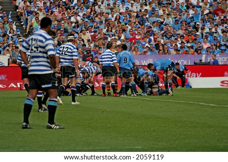 Rugby players in a loose scrum