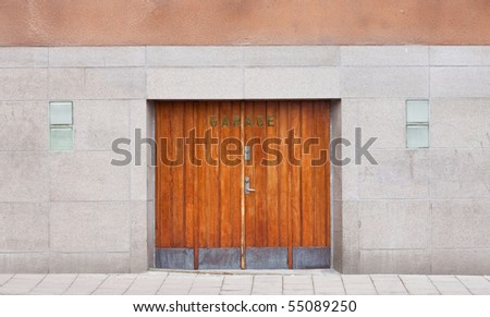 Old wooden garage door on a stone wall