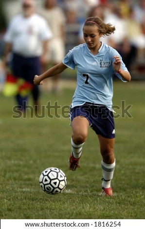 high school girl soccer player about to make a move with the soccer ball
