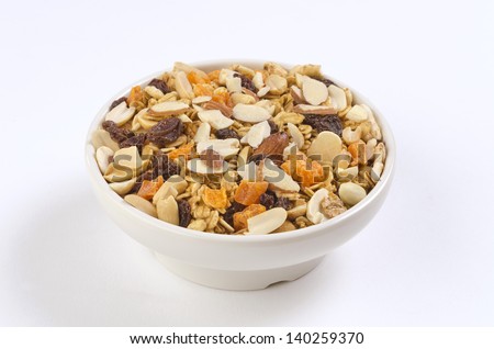 Granola Cereal bowl An isolated cereal bowl with almonds, raisins, dried fruit, peanut and oats