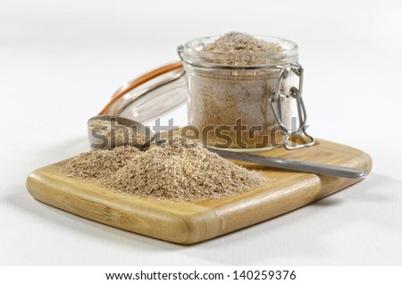 Wheat bran pile  A pile of wheat bran and jar on a white background