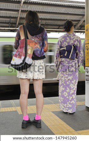 Traditional and modern fashion  An urban scene commonly encountered in Japan