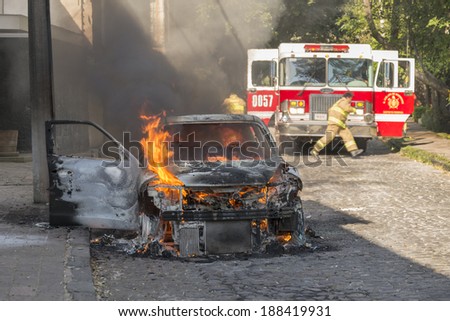 DISTRITO FEDERAL, MEXICO- JANUARY 22: Firemen arrive to help an already burnt car that caught fire due to an electric short circuit. This image taken on January 22, 2014.