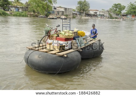 CHIAPAS, MEXICO- FEBRUARY 25: Merchant who owns a two tire raft used to cross goods across the Suchiate rives that divides Mexico and Guatemala. Photo taken from Mexico on February 25, 2011