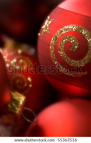 Red baubles with gold shimmering imprints close up