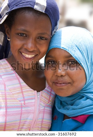 CAIRO - AUGUST 29. Two nubian girls, 8 years old, from Cairo, smiling to camera after selling to me some souvenirs. August 29, 2008 in Cairo, Egypt.