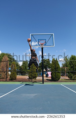 Young basketball player flying to the hoop for a monster jam.