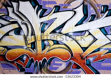 Colorful graffiti spray painted on a brick wall.  Makes a great background or backdrop.