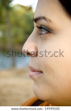A side profile closeup of a young Spanish womans face.