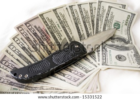 A knife and some fanned out cash laying on a bed.  This works for all sorts of illegal activities such as prostitution, drug dealing, and gang activity.