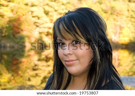 A young woman with highlighted hair in a new england setting during autumn.