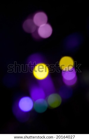 An abstract bokeh background with blurred light blobs.