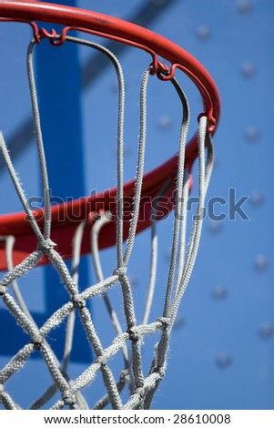 Closeup detail of a playground basketball goal and net.  Shallow depth of field.