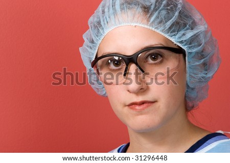 A young surgeon isolated over red with copyspace.