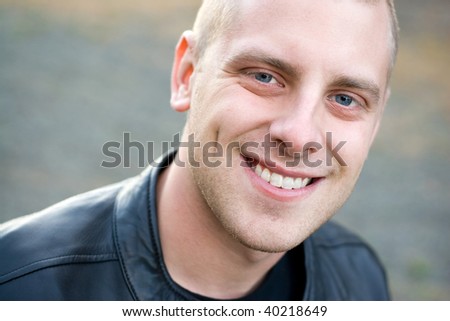 Closeup of the face of a happy young man with a big smile.