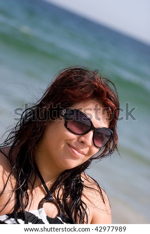 Portrait of a pretty plus size model at the beach.