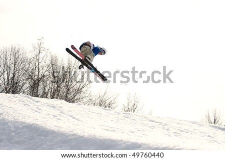 A skier catching some major air after launching off of a jump.