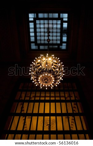 A large hanging chandelier inside the New York Grand Central Terminal train station.