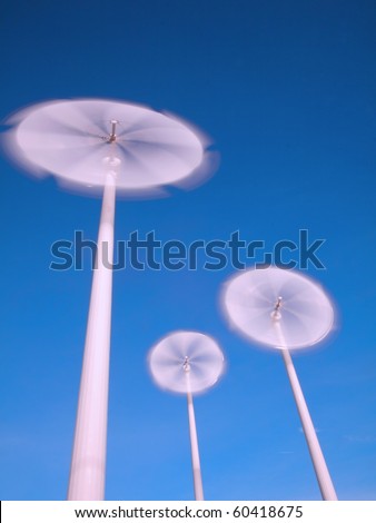 motion blade of modern win turbine in windy day with blue sky.