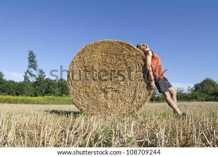 man sunbathing at rural field on a summer day