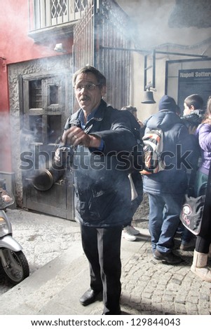 NAPLES - JAN 30: Unidentified senior man offers superstitious rituals for money at the entrance of \