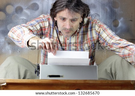 Busy man typing on old typewriting machine