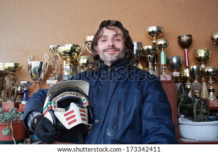Pilot pose with helmet over a victory cup background