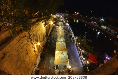 ROME, ITALY - JUNE 29, 2014: People of Rome enjoy the summer nights along the lively banks of the Tiber river