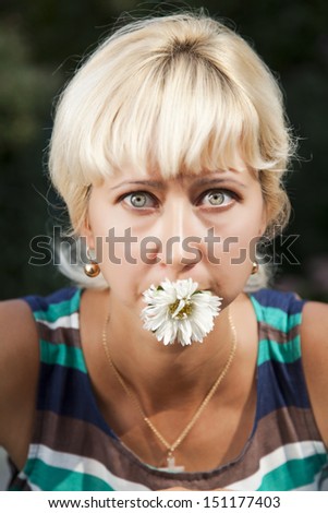 young beautiful woman with flower.portrait of attractive caucasian smiling woman blond