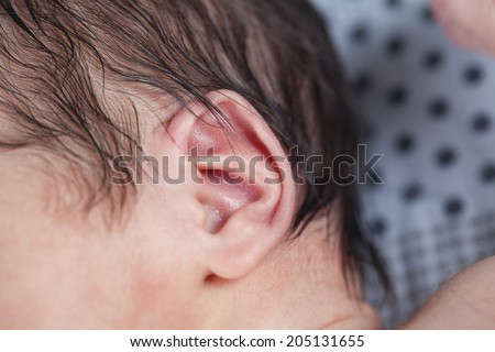 Small delicate little ear of newborn. close up of baby ear
