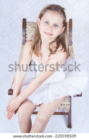 Portrait of an adorable preschool age girl playing dress up wearing a ballet tutu, isolated on white
