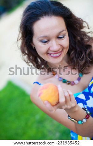 Woman. peach in woman hands